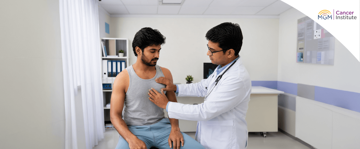 Man checking chest for lump early sign of male breast cancer